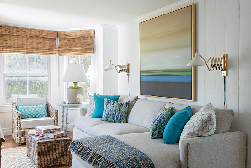 Color Play: In the family room, colorful pillows from Indigo Market complement the abstract landscape from Wendover Art Group.