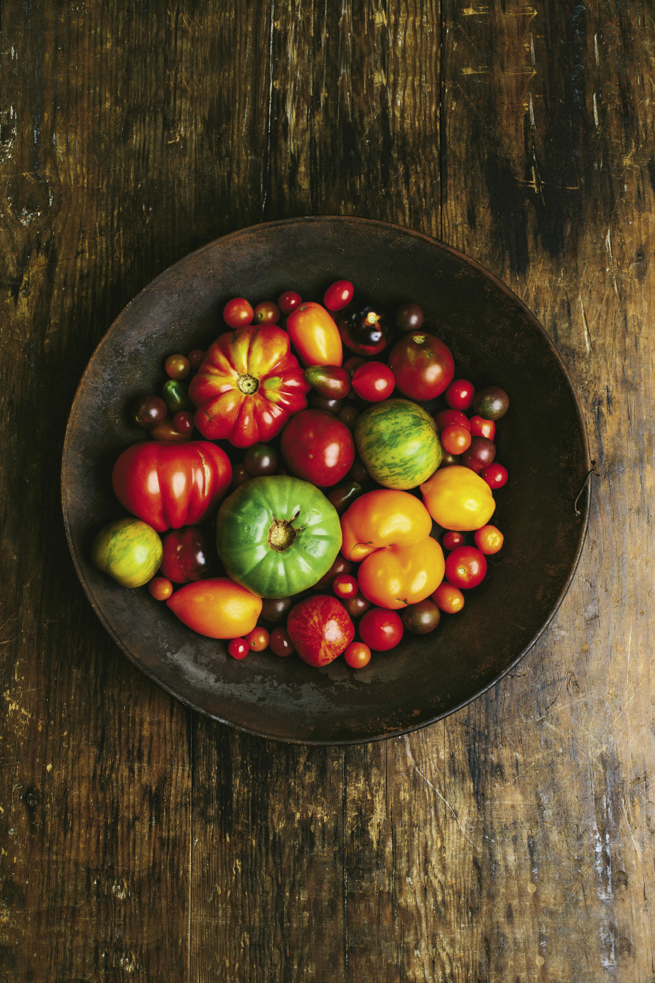 Summer’s Bounty:  A bowlful of locally grown heirlooms,  including the large red Costoluto Genovese, the striped red Tigerella and Green Zebras, and Orange Bananas