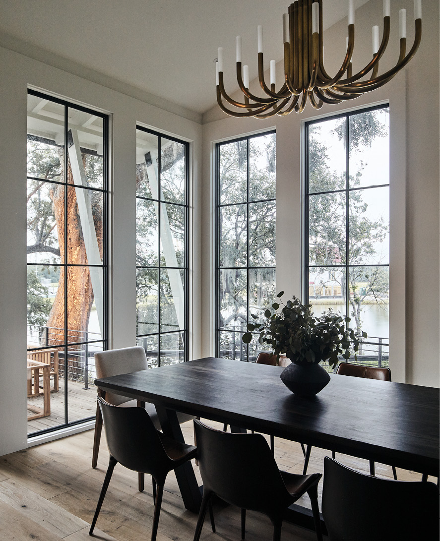 A brass chandelier highlights the dark walnut table in the streamlined dining room.