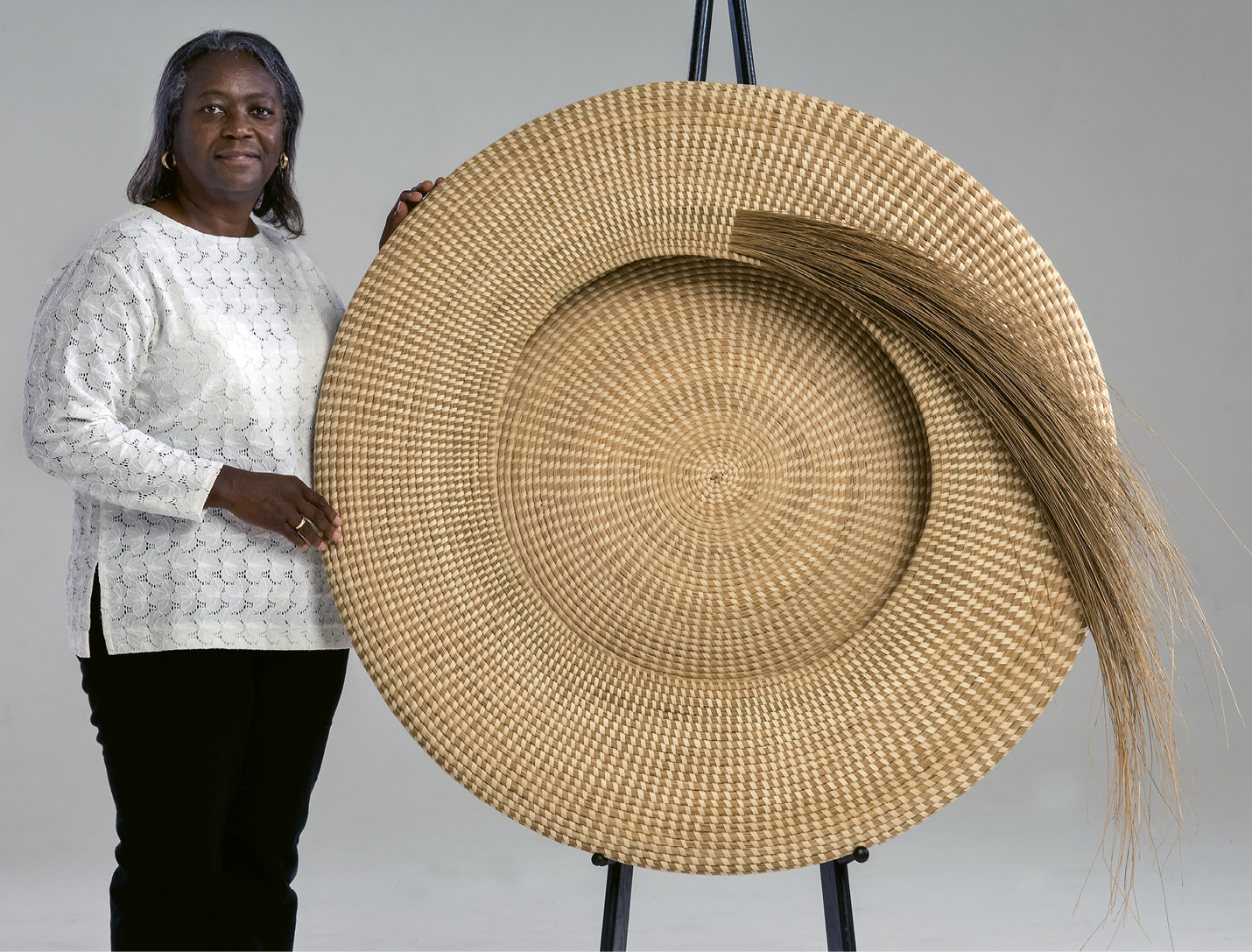 One &amp; Done: Commissioned by a patron who later donated it to the Gibbes, Jackson’s Never Again (2007, sweetgrass and palmetto, 42 inches) took three years of intricate work. A masterpiece of craft, the shape harkens back to the traditional flat rice baskets, but takes it to a soaring new level.