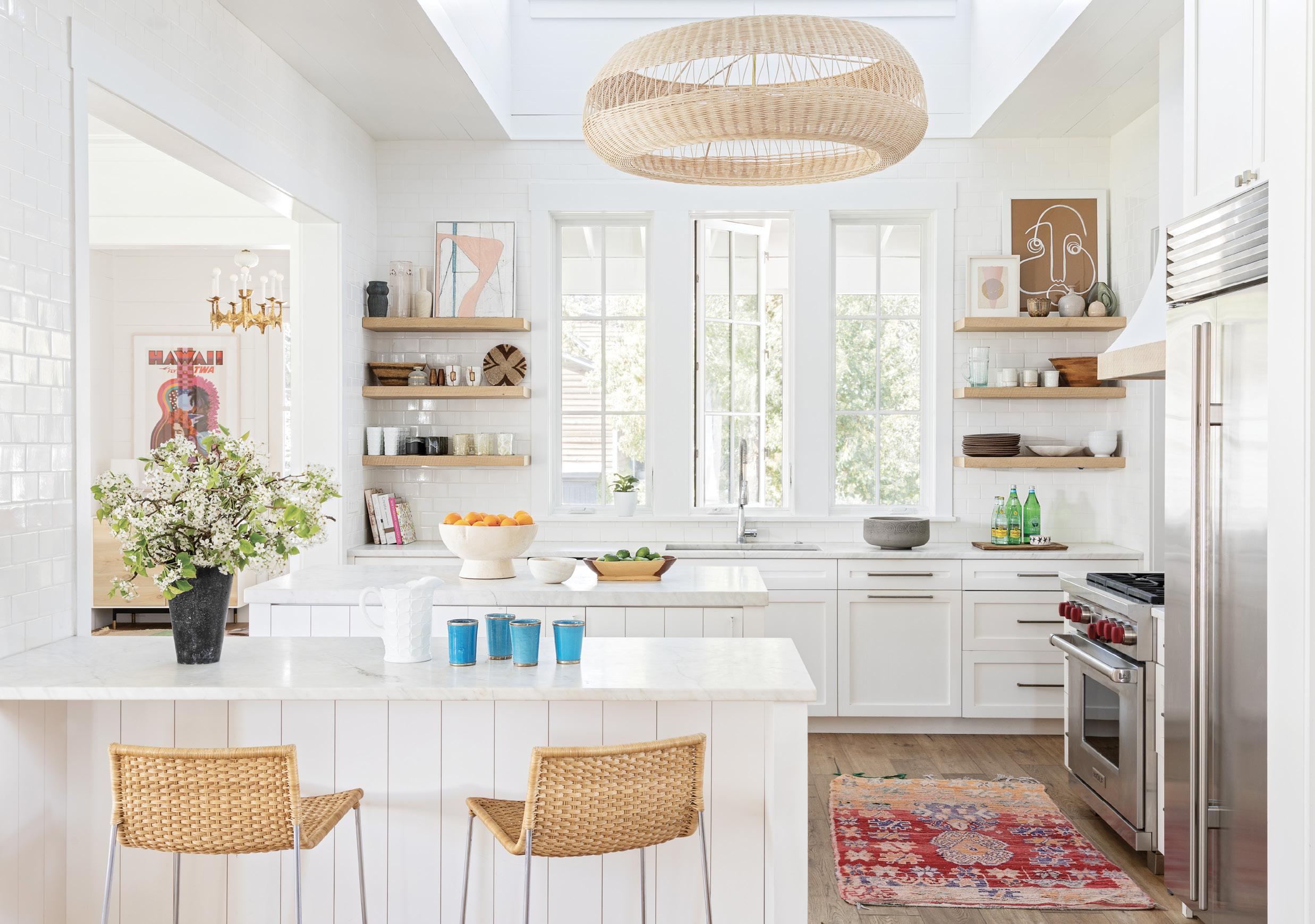 TIME FOR TEXTURE: The bright, white kitchen was revived with some key texture changes: wooden shelves replaced painted ones and a stainless steel hood was swapped for plaster trimmed in oak.