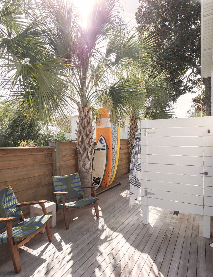 Just outside, a surfboard rack and outdoor shower make it a practical drop zone, too.