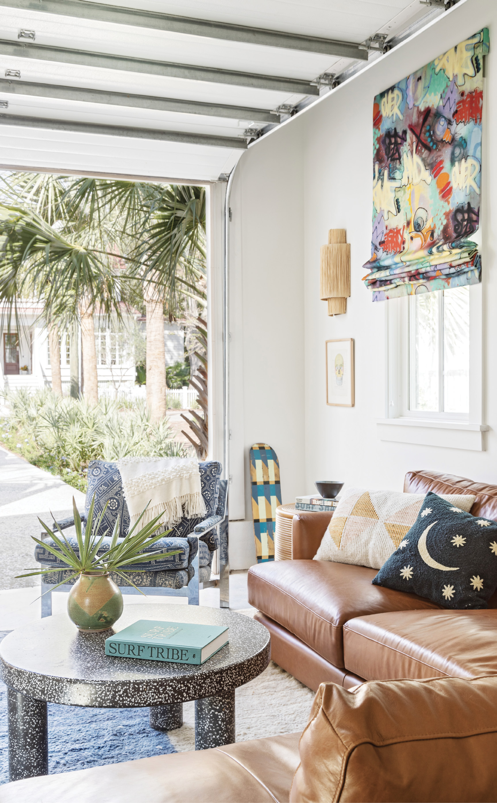 Teen Scene: Stone and leather (in the form of a terrazzo coffee table from Anthropologie and sofa from West Elm) are durable yet great-looking choices for the garage-turned-kids’ hang space.