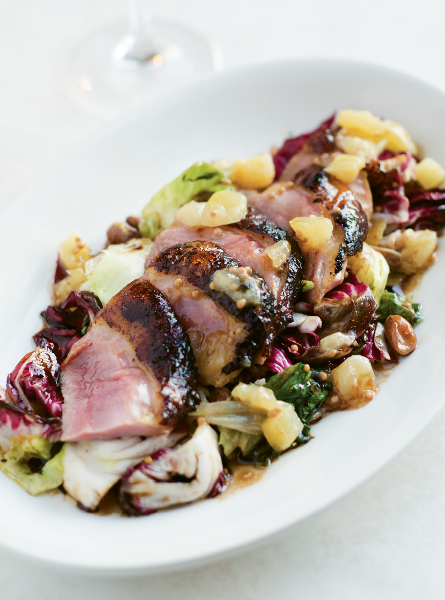 In Luck with Duck:  Slices of tender roasted duck breast with grilled radicchio and escarole and a spicy apple mostarda.