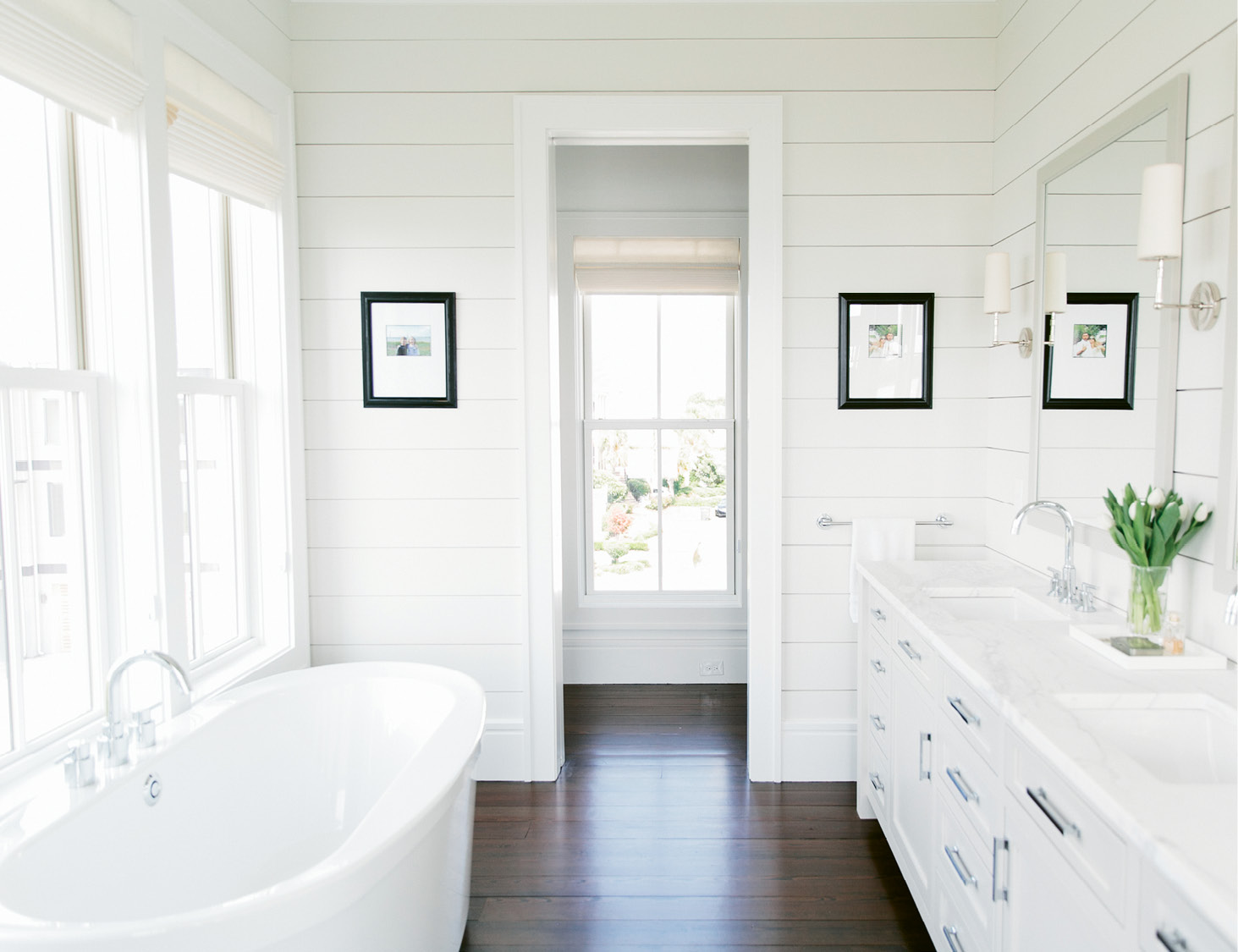 Mid-century furnishings feel clean-lined and simple, while shiplap walls in the master bath nod to coastal cottages.
