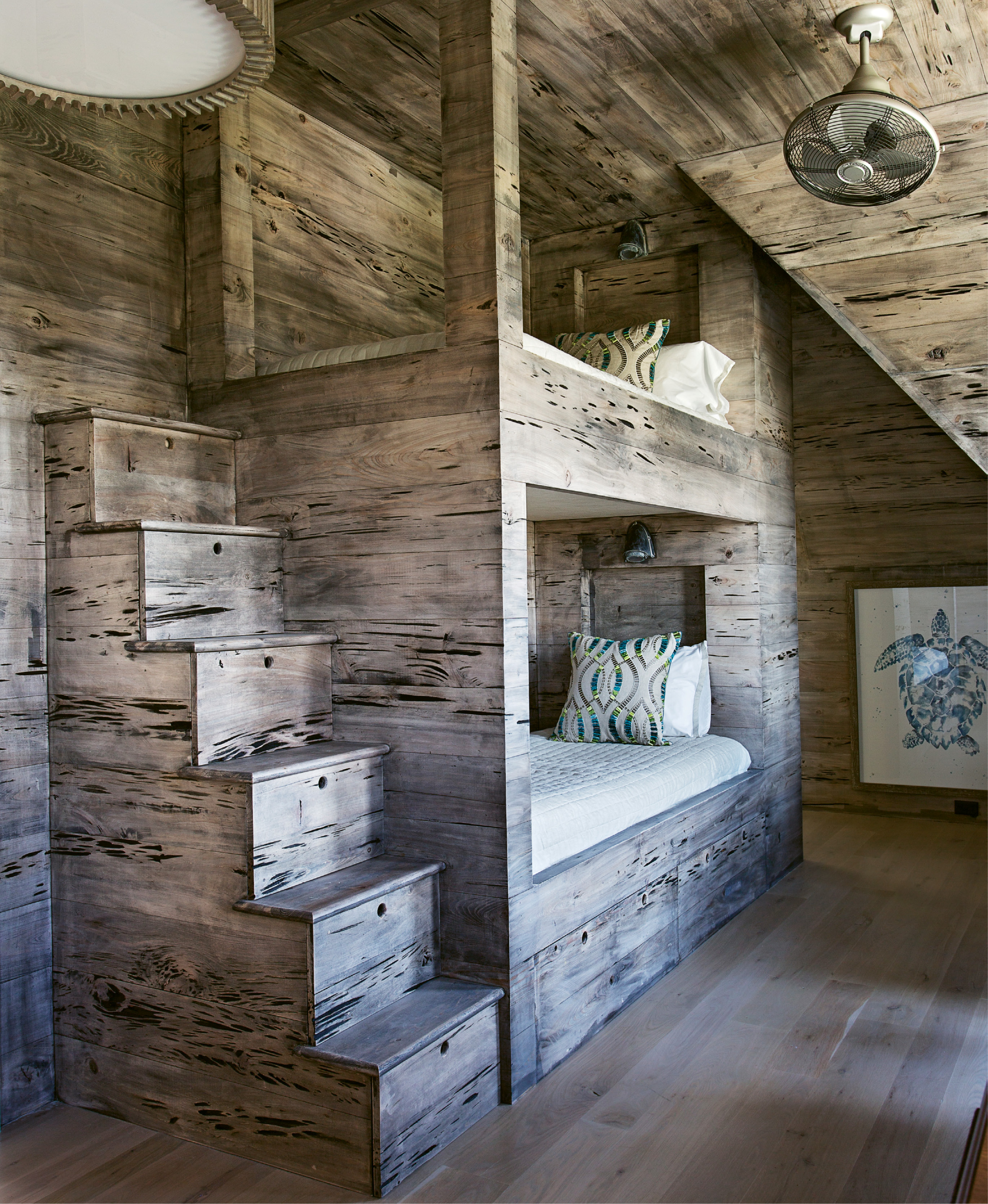Pecky cypress walls warm up the bunk room, which boasts four beds and two en suite baths.