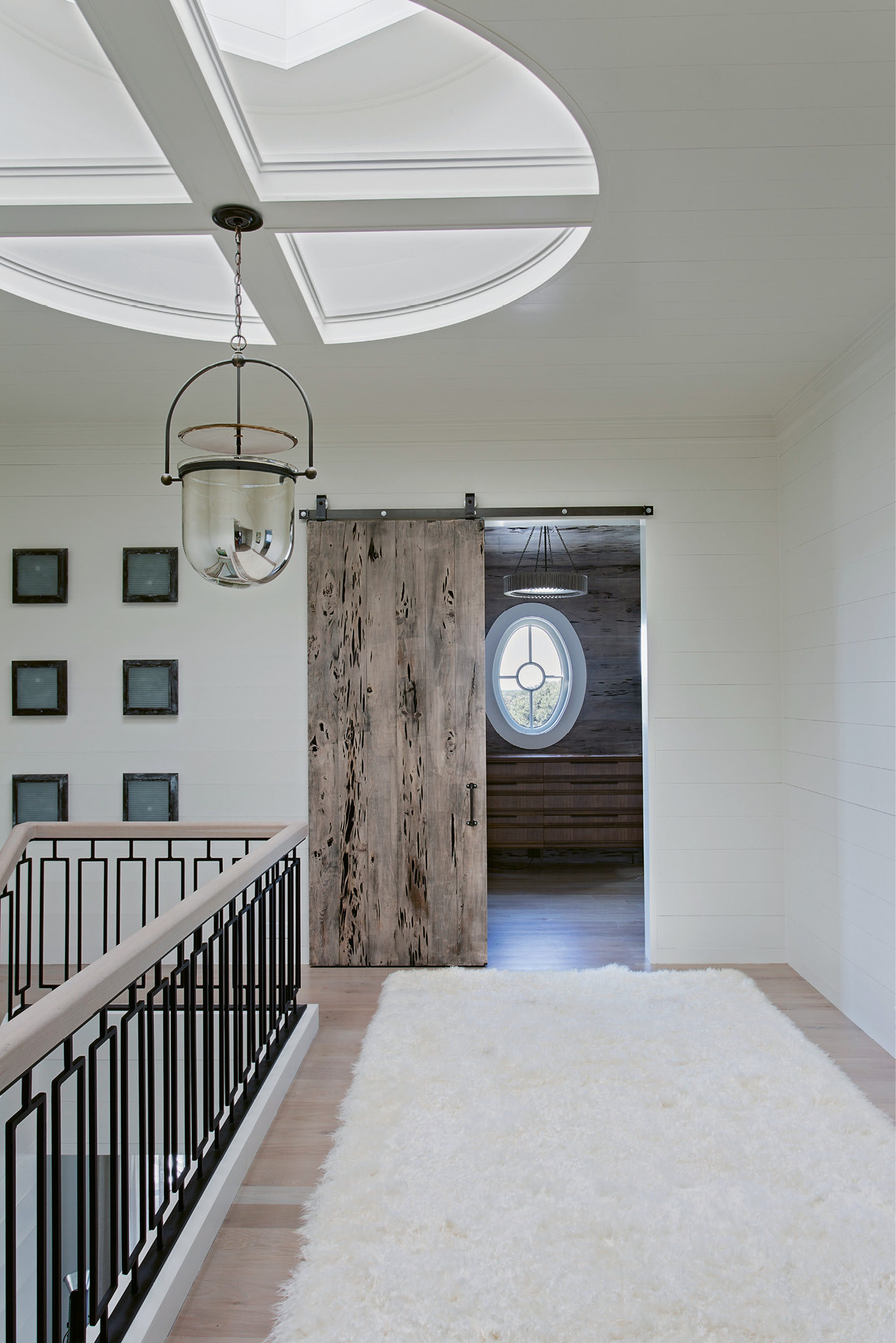 Haute Hallway: A medallion-shaped skylight presides over this second-floor hallway with a custom stair rail designed by David Smith.