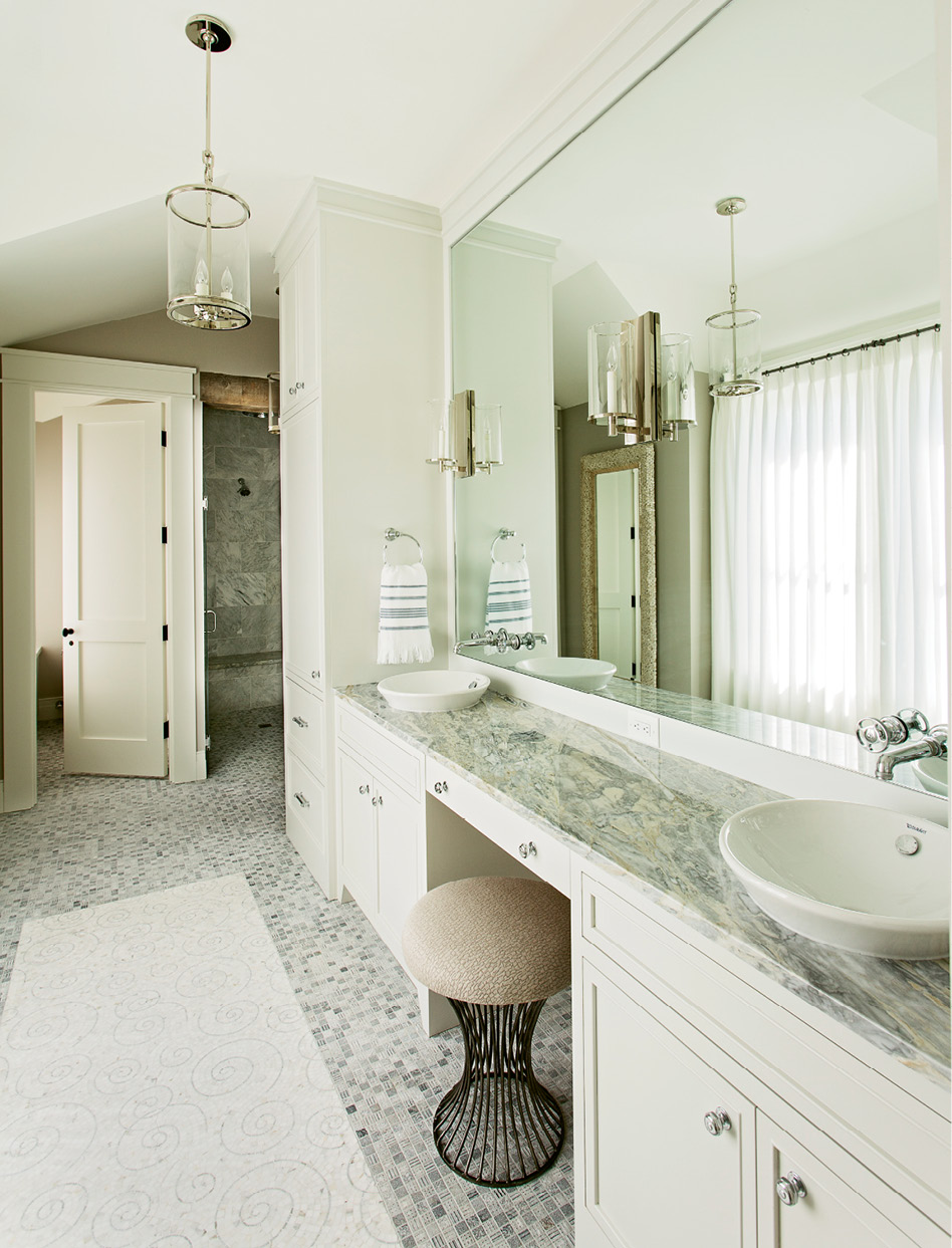 Waterworks fixtures and a Walker Zanger mosaic marble tile floor set an elegant tone in this bath.