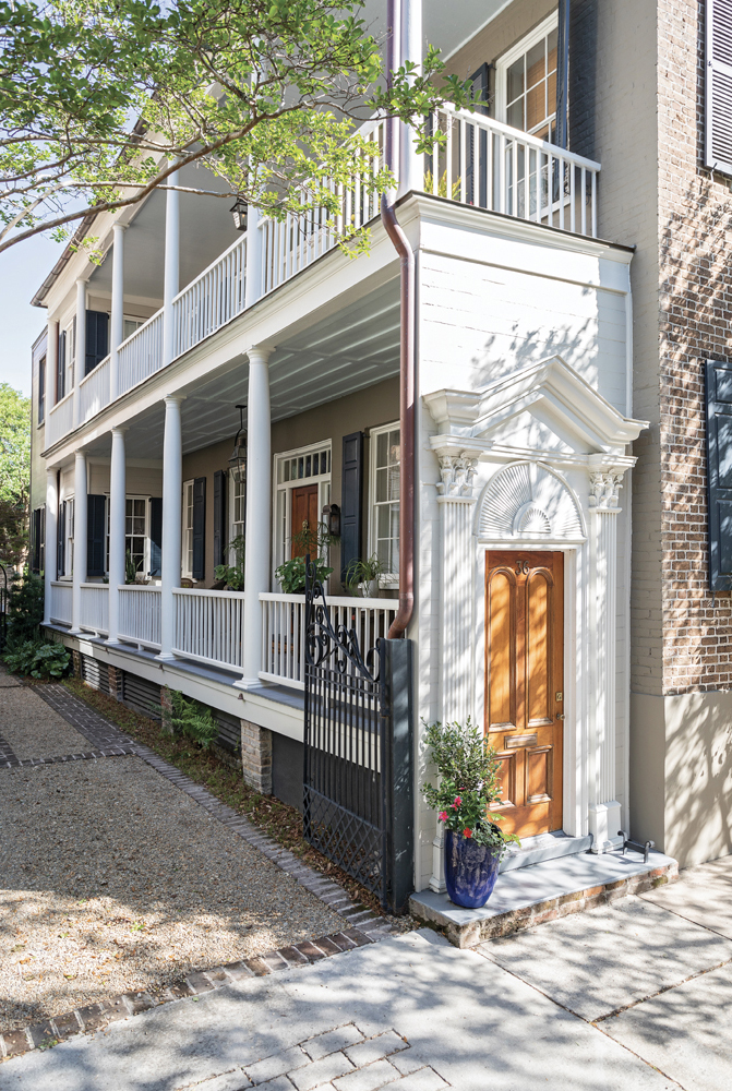A WARM WELCOME:  The grand three-story Charleston single house, which was built in the wake of the city’s 1838 fire, has been impeccably preserved. A pair of Philip Simmons gates and ornate Greek revival moldings welcome visitors to the brick home, which, true to single house fashion, boasts a pair of breezy piazzas.