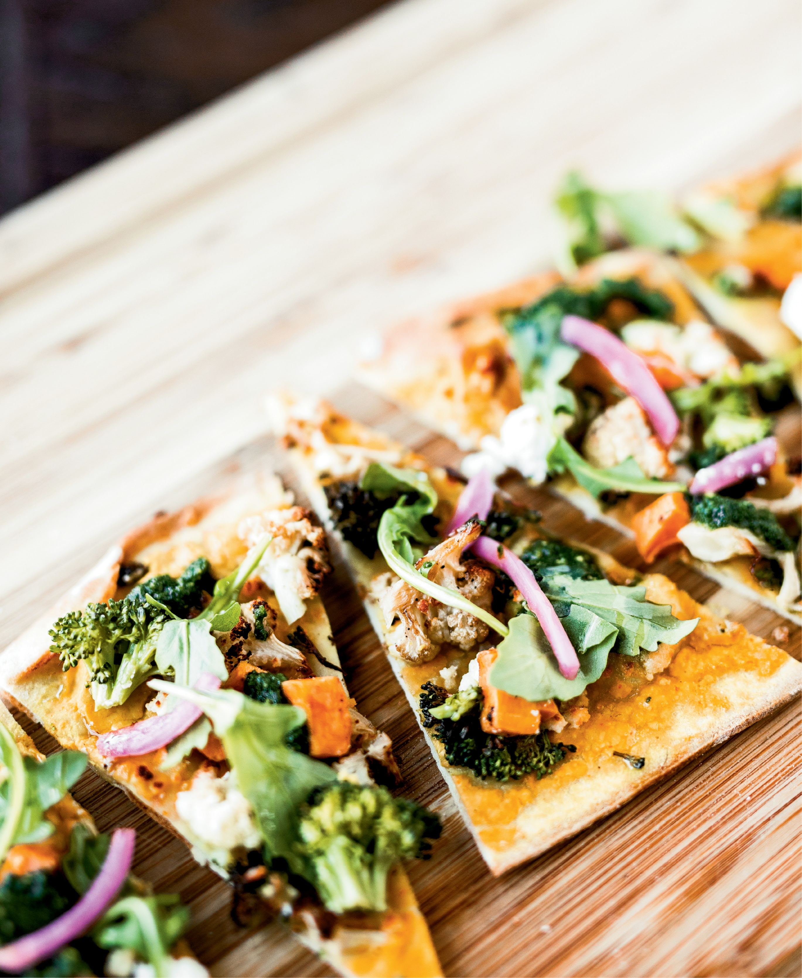 Fresh-picked produce was the norm when executive chef Brannon Florie visited his grandfather’s Mount Pleasant farm growing up. Now, he uses local sweet potatoes, broccoli, cauliflower, and other vegetables to add flavor to flatbread at The Granary.