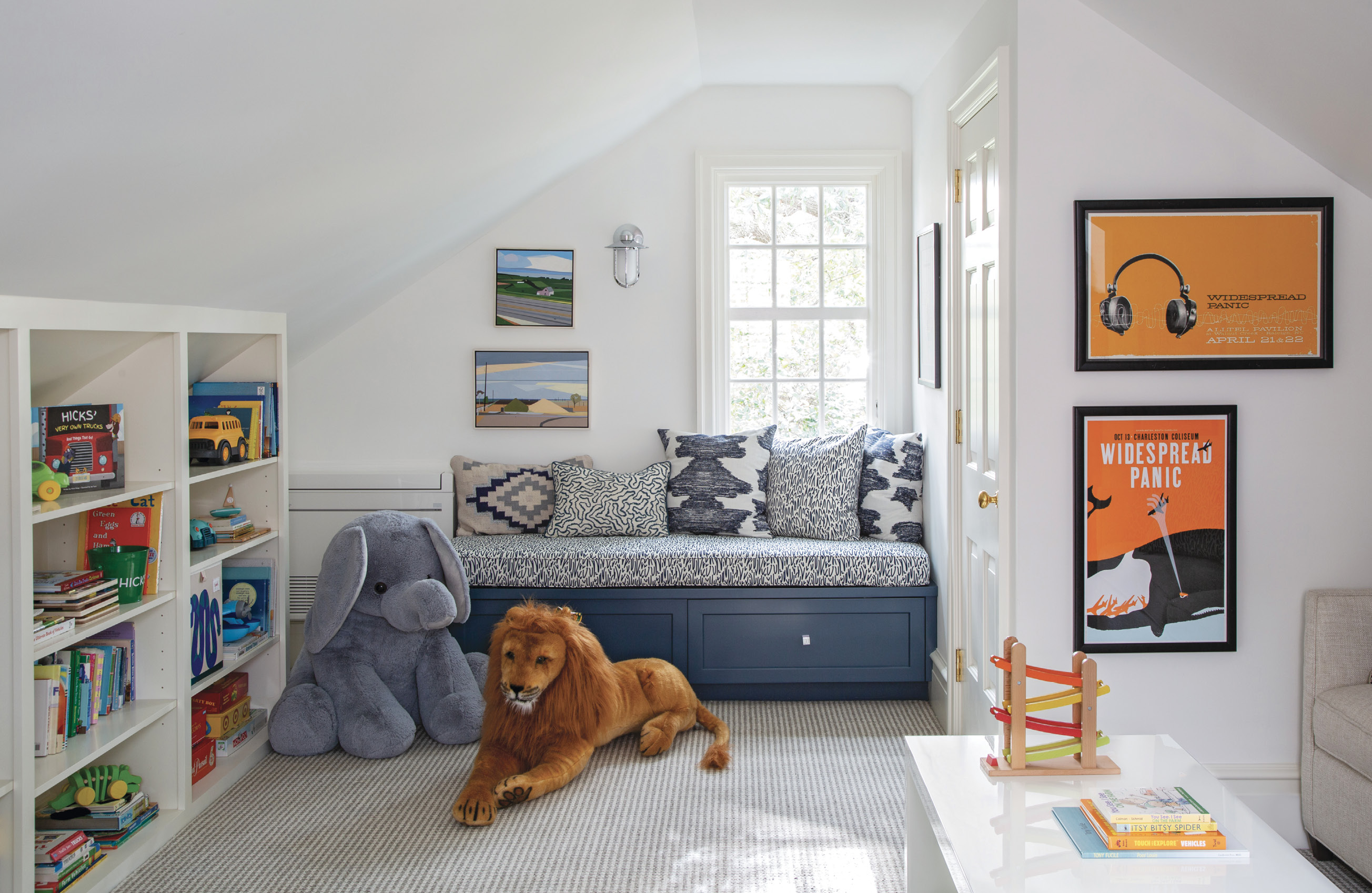 FLAIR PLAY: After connecting the room above the garage to the house via a new multipurpose laundry room/office, it became a playroom, with plenty of space for Tucker and Hicks to commune with their toys and their dad’s poster collection.