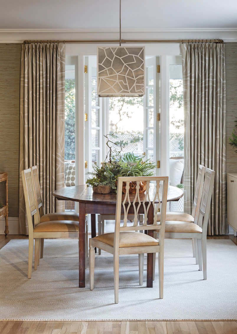 Just inside, the dining room’s grasscloth wall covering from Kravet lends an earthy, outdoorsy feel to this elegant space, which welcomes in even more natural light thanks to a window relocated from the master suite.