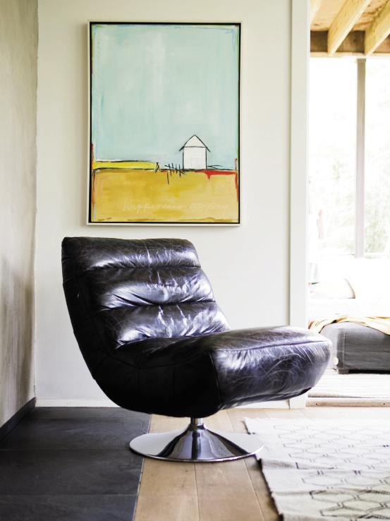 This retro  leather swivel chair gives the relaxed family room a little edge. The painting is by Aspen artist Tori Mitas-Campisi