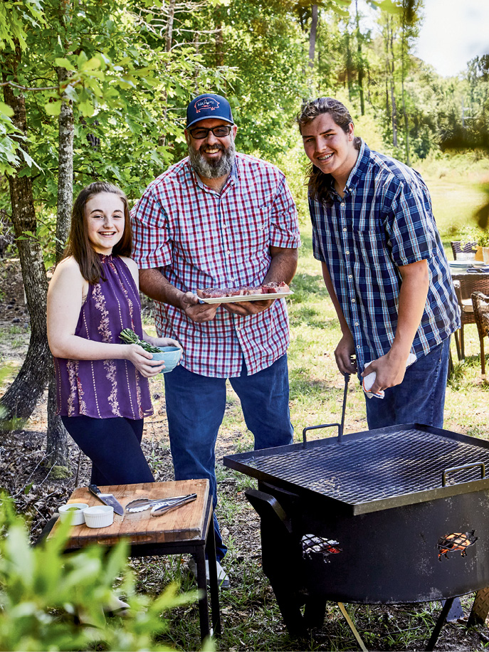 Swig &amp; Swine owner Anthony DiBernardo (left with his children, Mia and Asher) spends his days off outside by the grill, preparing favorites like herb-brushed steaks and grilled corn salad.