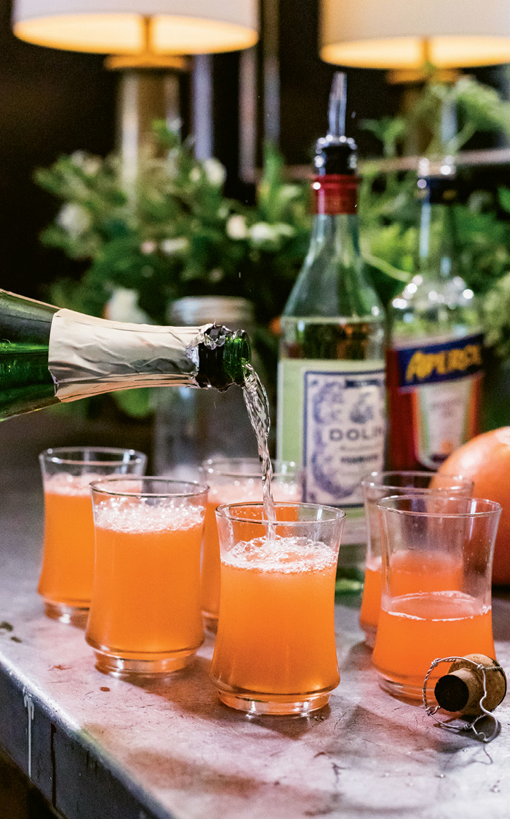The bright grapefruit cocktails get topped off with bubbly.