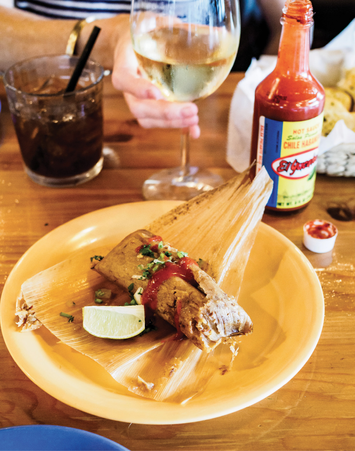 Unwrapping a tamale at Rancho Alegre