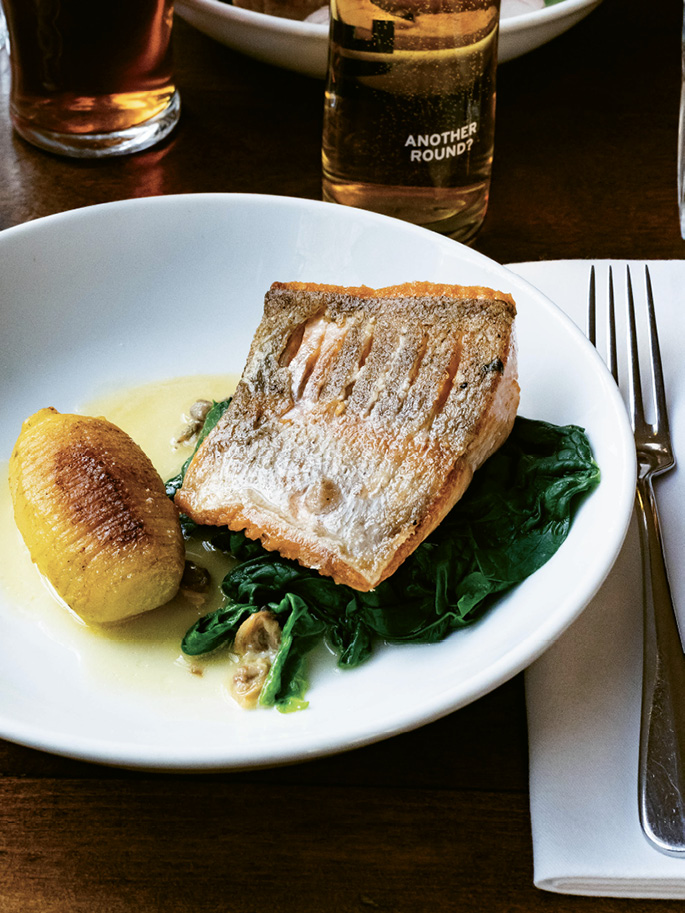 Pan-fried trout with Charlotte potato, sauteed spinach, and cockles at The Thomas Cubitt
