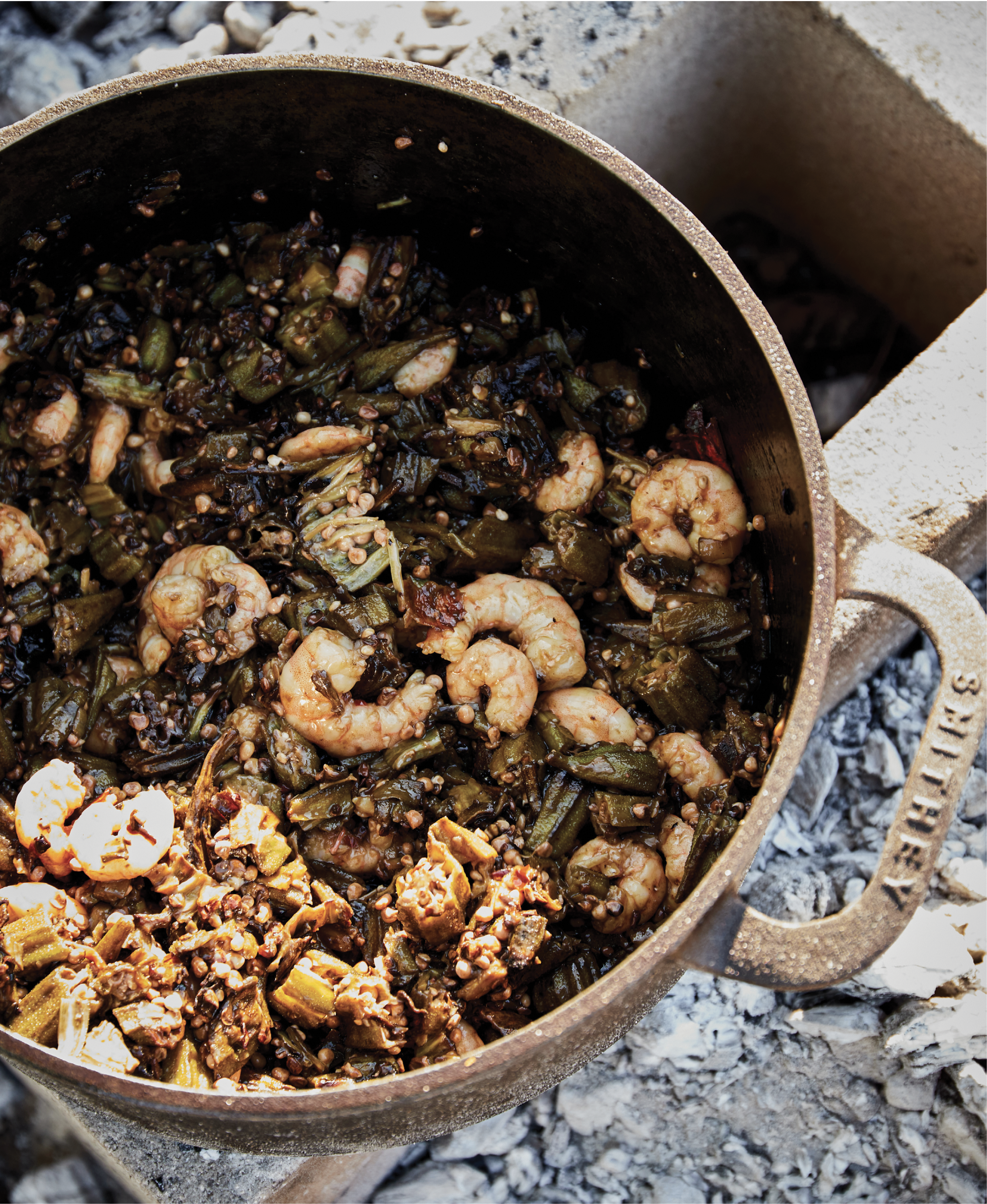 Okra, collards, and shrimp  develop a subtle smoky flavor while being cooked over coals.