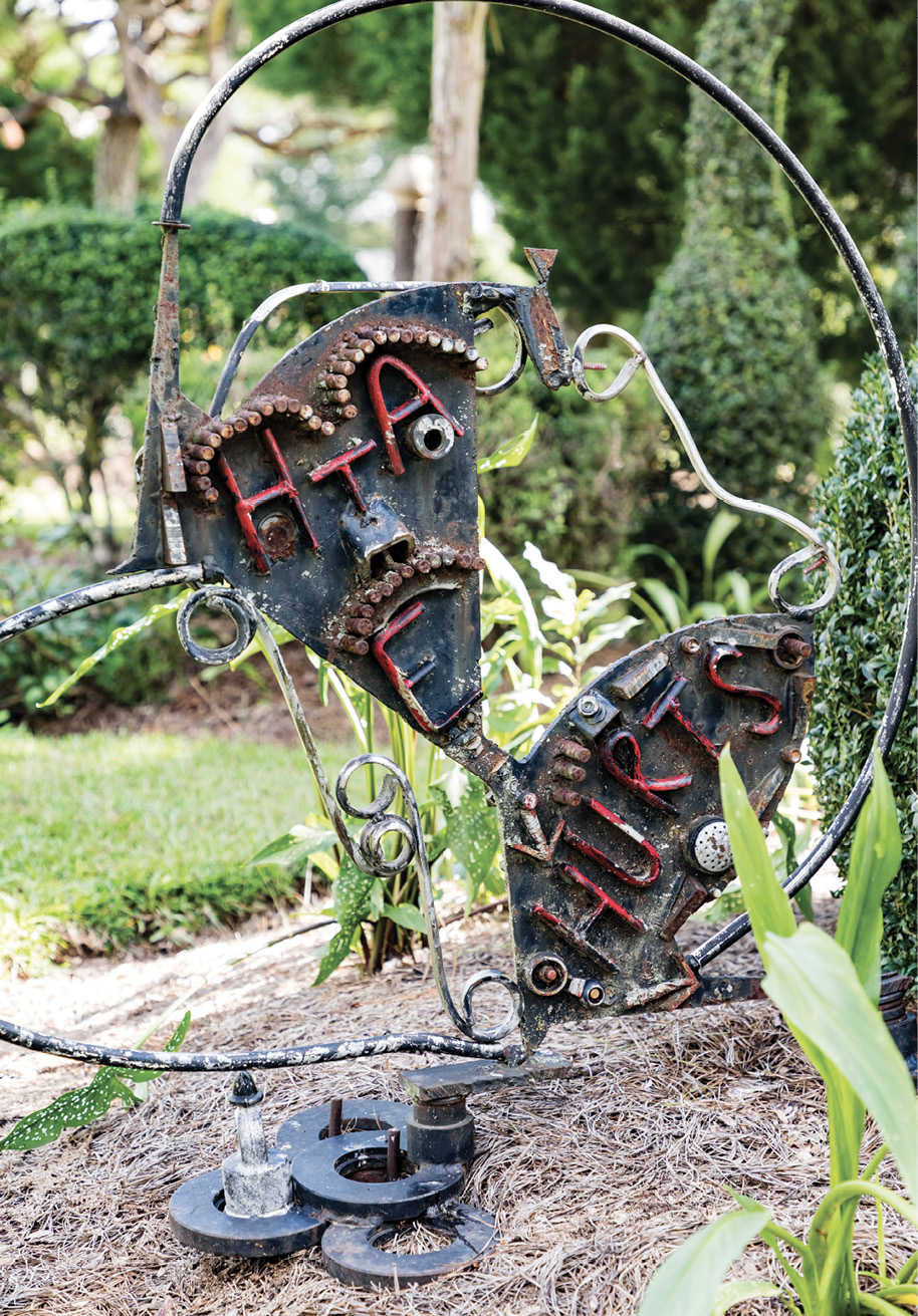 WORDS OF WISDOM: Over the years, Fryar has added more fabricated sculptures as counterparts to shrubs and trees. He uses metal pieces, pottery, bottles, and other found objects. Sometimes he adds lettering, such as for the metal sign with “Hate hurts” and an arrow pointing downward. The other side reads “Love and Unity,” with an arrow pointing upward.