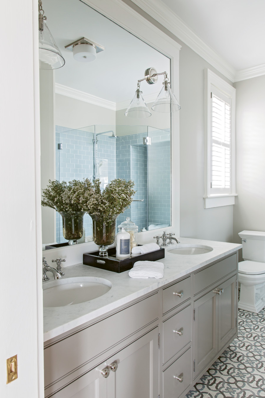 Floored: “I loved the simplicity of the pattern,” says Peake of the cement tiles that set the tone for the master bath. Tiling the bathrooms was the only instance where the original floors were altered.