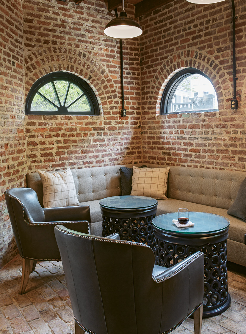 For this lounge area, designer Kristin Peake echoed the motif with cylindrical side tables, spinning barstools, and round mirrors to soften the hard lines of the floorplan and exposed brickwork. See the electrical outlets mounted on the walls? That’s another flood-proofing trick to prevent inevitable storm surges from wiping out wiring that runs along ground level. There’s no insulation on the bottom three feet of this floor. “It’s all brick, which can take the water,” says Rick. “We’ll just pump anything out.”