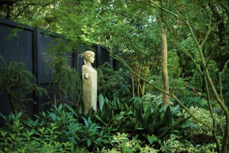 Garden Keeper: Surrounding a maiden statue—one of four, each representing a season—are lush iron plant and deodar cedar.