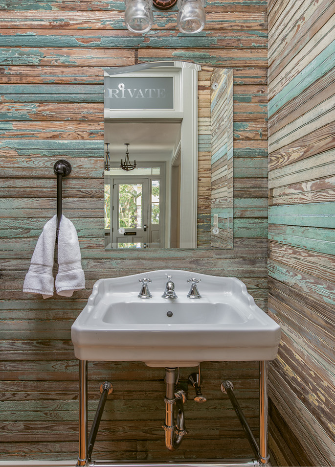 Though not original to the house, the half-bath adds some much-needed 21st-century convenience; beadboard salvaged from the back porch was repurposed as wall paneling, retaining a sense of the home’s history.