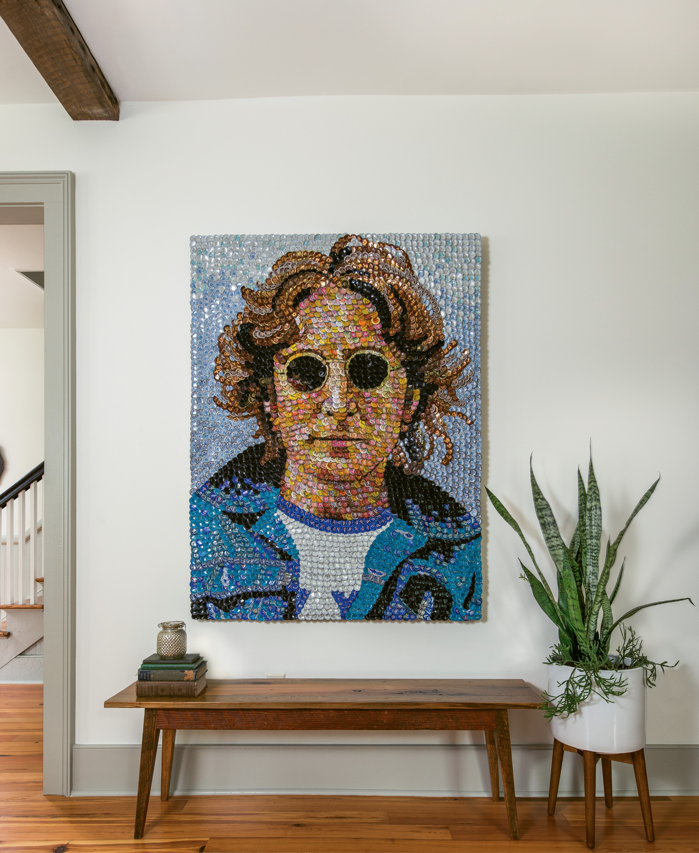 The couple kept the decor minimal in order to highlight the architectural features, but the accessories they do have pack plenty of personality. After admiring the work of local artist Molly B. Right for many years, the Ellsworths commissioned this bottle-cap portrait of John Lennon, which hangs above a custom Landrum table in the living area.