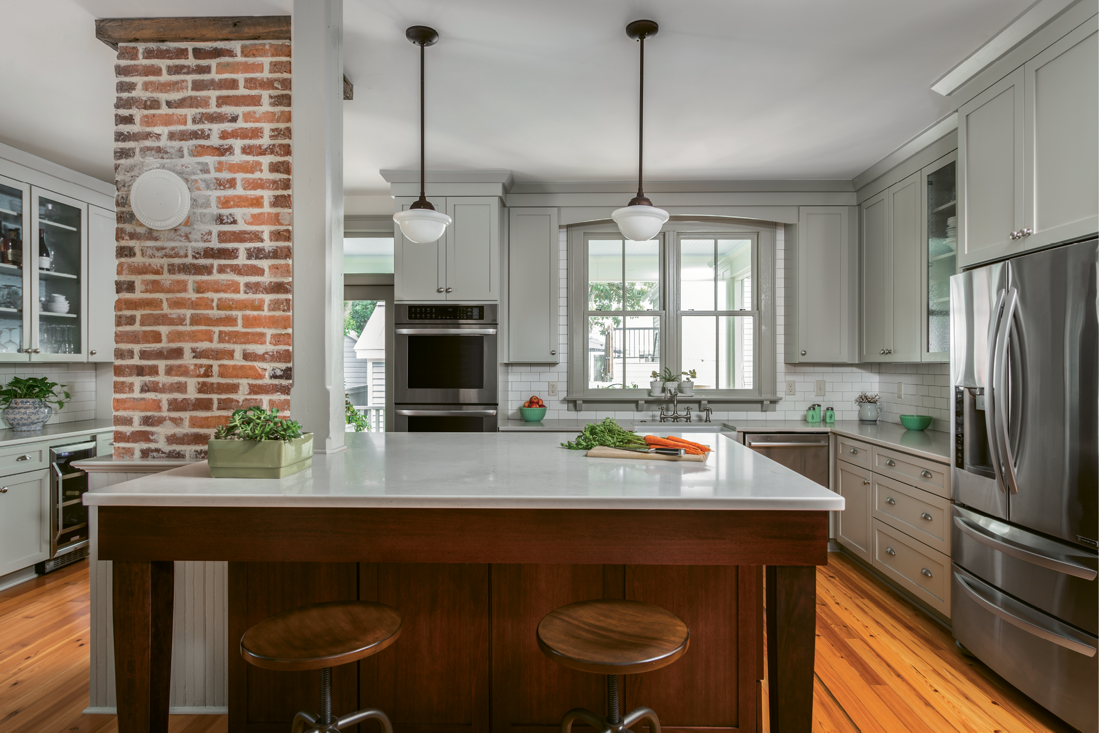 In the kitchen, Engelke repurposed an antique porch column to provide necessary structural support. Most evenings, the Ellsworths can be found here, eating dinner or just hanging out at the quartz-topped island.