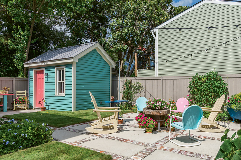 The coral door on the new gardening shed brings a fun dose of color to the scene.