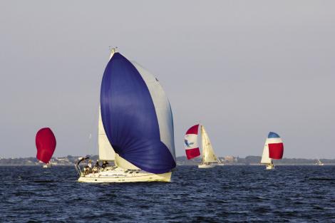 The fleet depends on colorful spinnakers for speed when they are sailing with the wind 90 degrees or more off the bow.