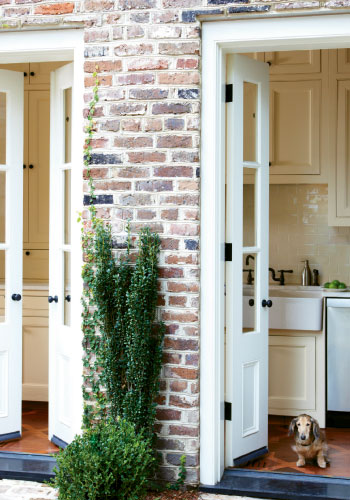 Adding French doors to its galley kitchen opened views to her courtyard garden