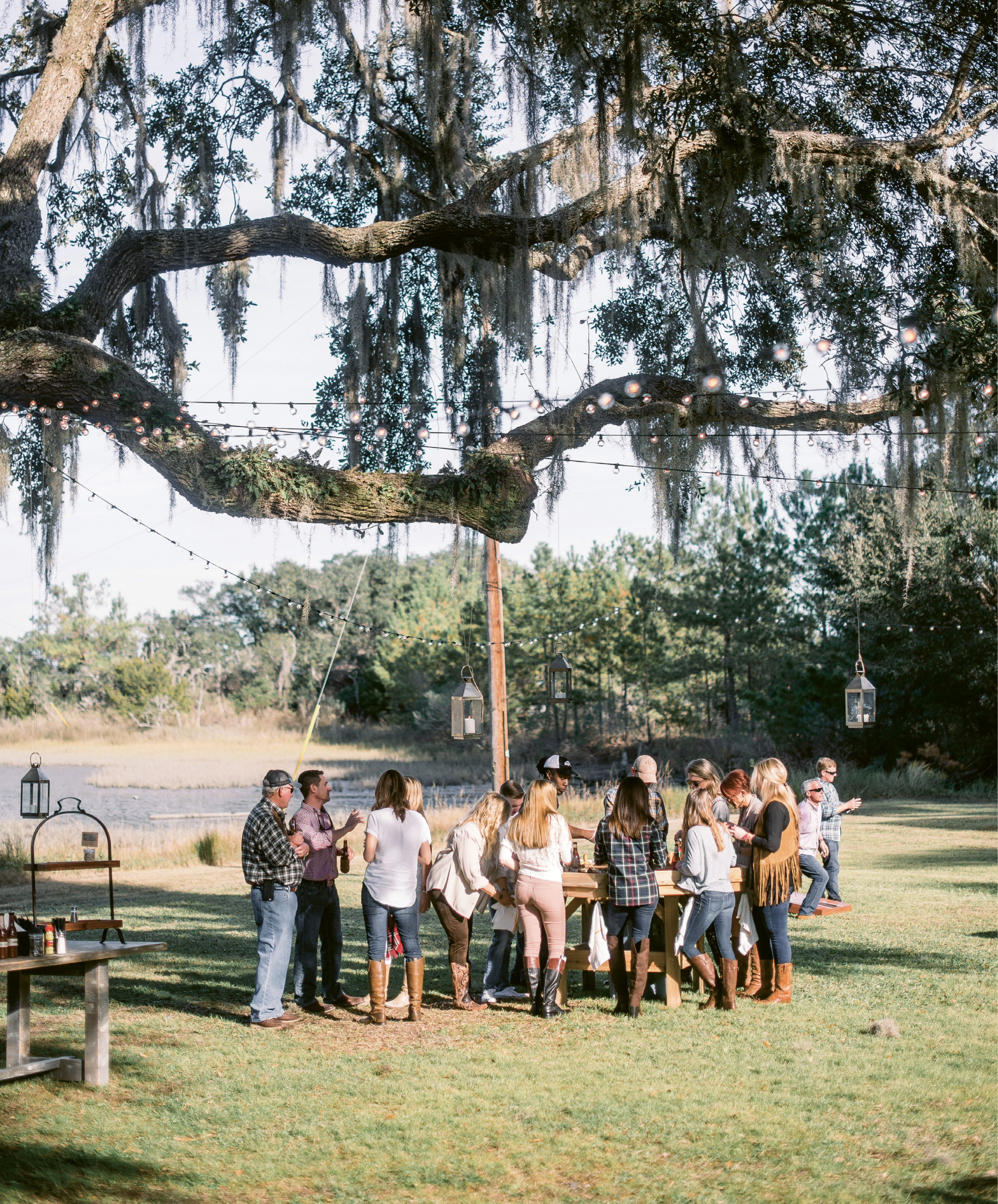Work the Space: The oyster table was placed in the shade of a grand live oak. With Spanish moss and resurrection ferns clinging to the branches above, the decor could be rustic and minimal.