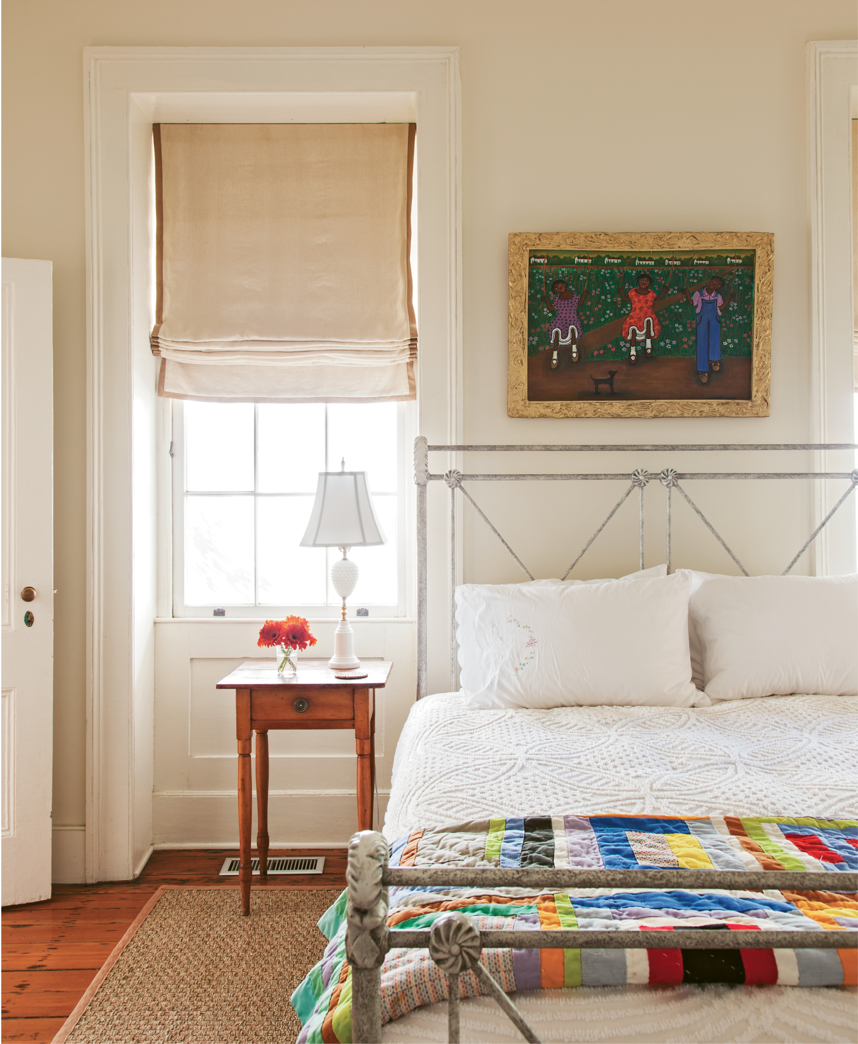 A neutral palette allows the colorful artwork—including a painting by Lorenzo Scott of Atlanta and quilt by Maggie Lou Williams of Bowman, South Carolina—to command visual attention.