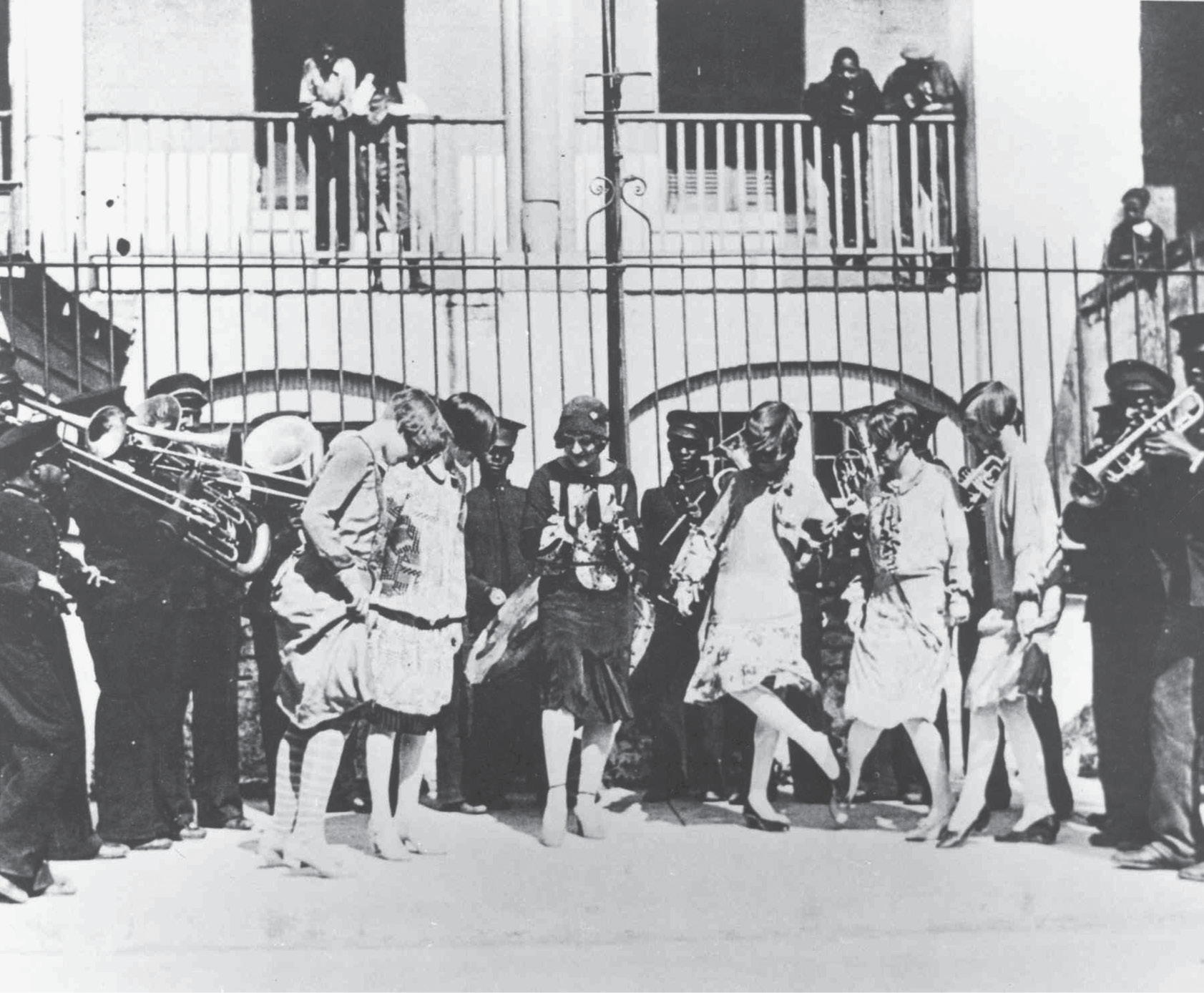 A group of flappers doing “The Charleston” alongside the Jenkins band outside the orphanage on Franklin Street, circa 1920.