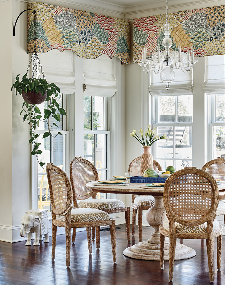 The drapery fabric from the living room appears again on the valances in the bright, white kitchen and breakfast nook.