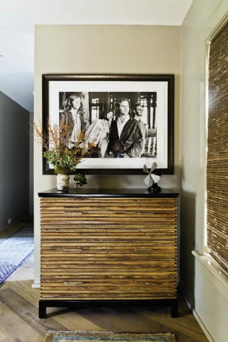 Rock the House: A black-and-white photo of The Doors by Henry Diltz hangs over a Brazilian wood chest by Environment in the foyer.