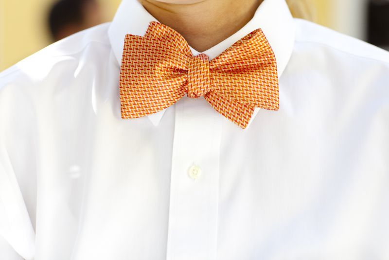 ALL TOGETHER NOW: The catering staff from Fish Restaurant suited up in apricot-hued bow ties, white tux shirts, and blue aprons.
