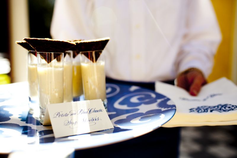 SPECIAL DELIVERY: White and bright blue melamine patterned plates dressed up the neutral-colored hors d’eouvres.