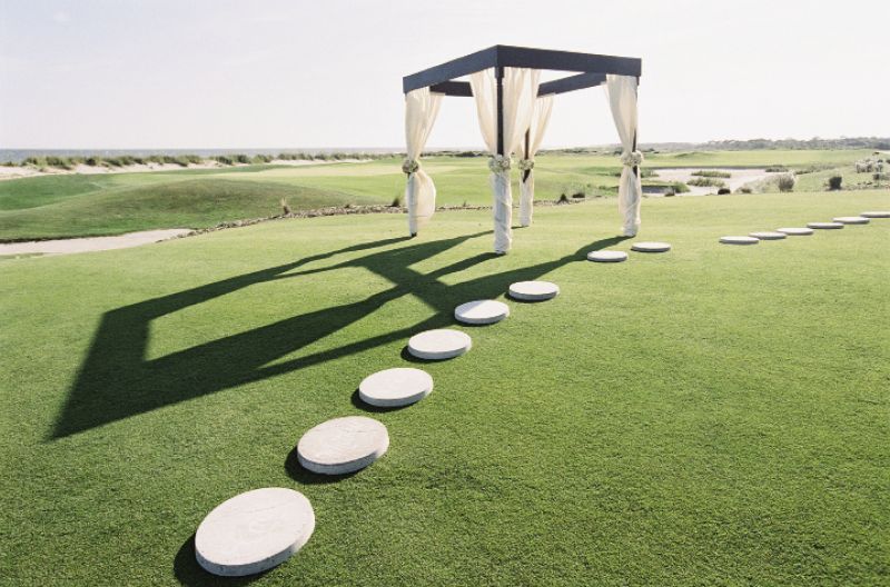 LANDSCAPING 101: The Soirée team constructed a draped canopy and arranged an arc of garden stepping stones where the bridesmaids and groomsmen stood during the ceremony.