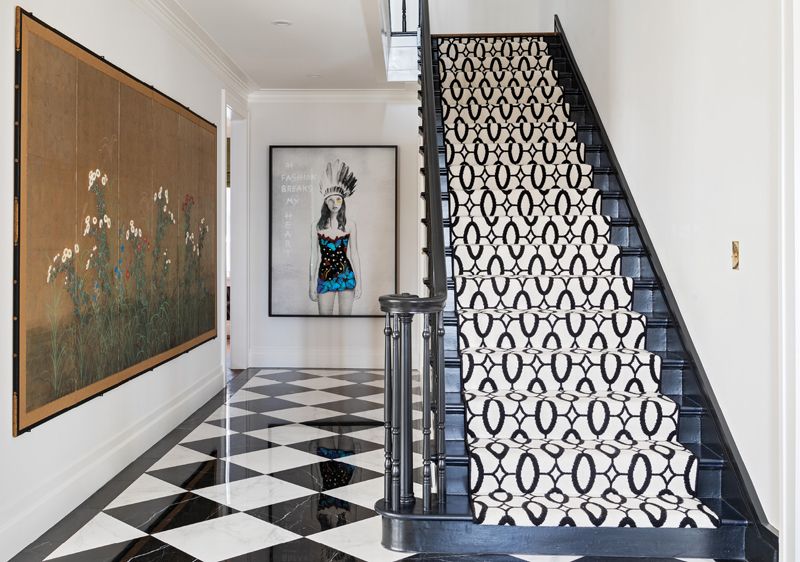 Surprise Inside: Expect the unexpected upon entering this genteel South of Broad mansion. The dramatic foyer sets the stage for a house where each room is a revelation—the design equivalent of a box of chocolates. Dominated by a black-and-white marble floor and a monochromatic Stark stair runner, the space draws visitors in with the alluring eyes of Kate Moss in a mixed-media piece, Fashion Breaks My Heart by SN, juxtaposed with an antique Japanese screen from the late 19th century.