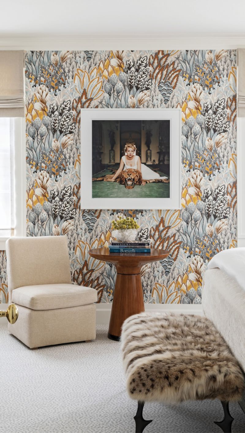 Scene Stealer: Slim Aarons’s 1959 photograph Beauty and the Beast is the centerpiece for the guest room. The golds and browns of the Casamance wallpaper are highlighted in the playful portrait and the Randolph &amp; Hein “Taza” table.