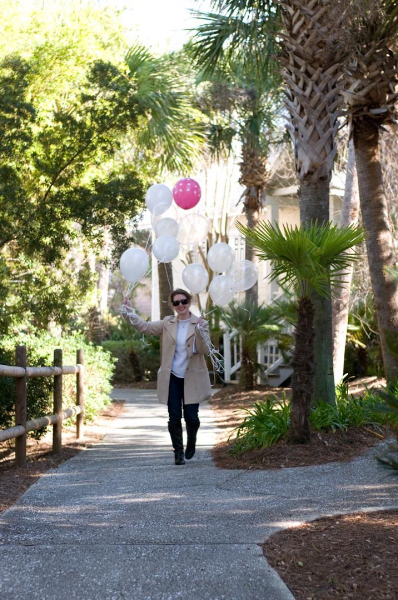 Della MacNicholas, director of development for the weddings division and head of our blog, TheWeddingRow.com, helps out with the balloon shot. Looking for great balloons? We found these at Party Plann-It (pink and white polka dots!), and had Hughes Party Rental fill them up. Photograph by Taylor Horton