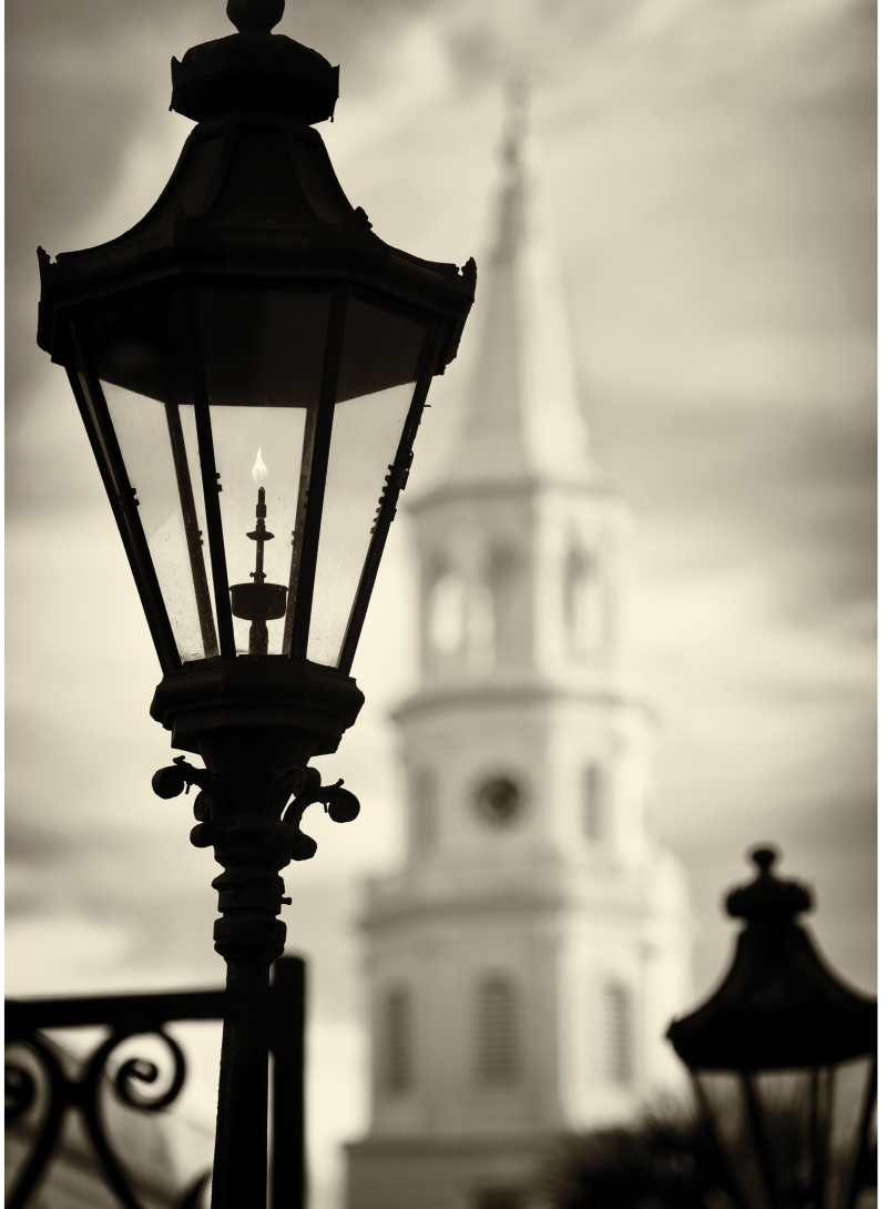 Gaslight lanterns at Hibernian Hall frame the iconic Saint Michael’s Church.