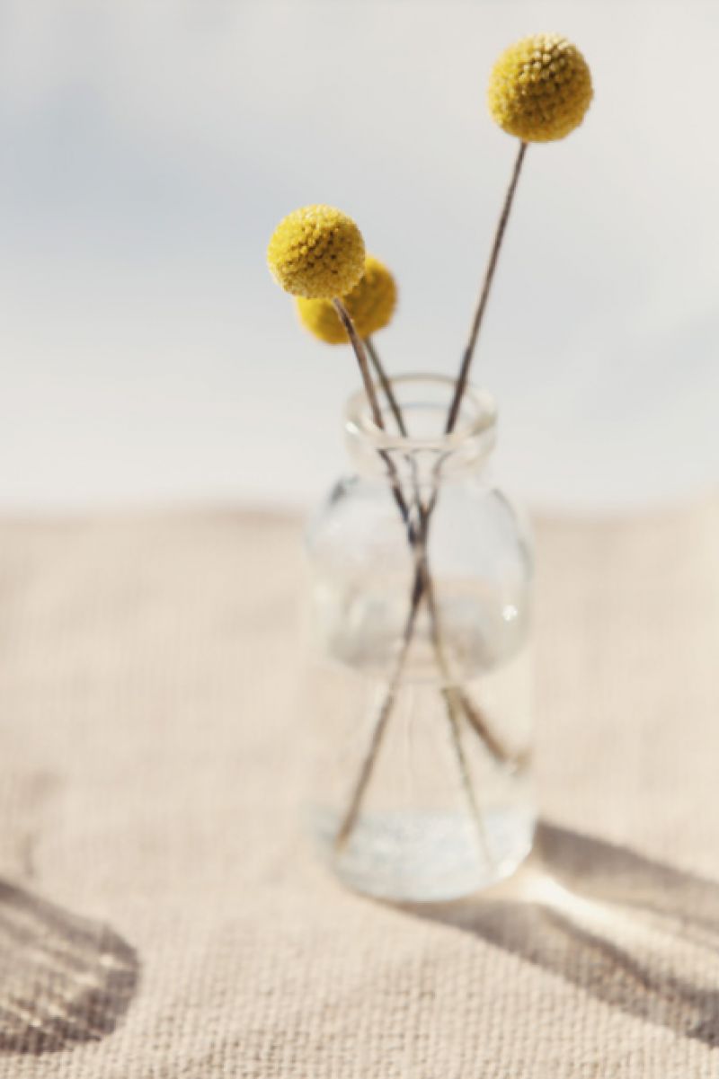 COLOR ME PRETTY: Punches of color like these yellow pompom dahlias brightened up the neutral palette and complemented the yellow bridesmaids’ dresses.