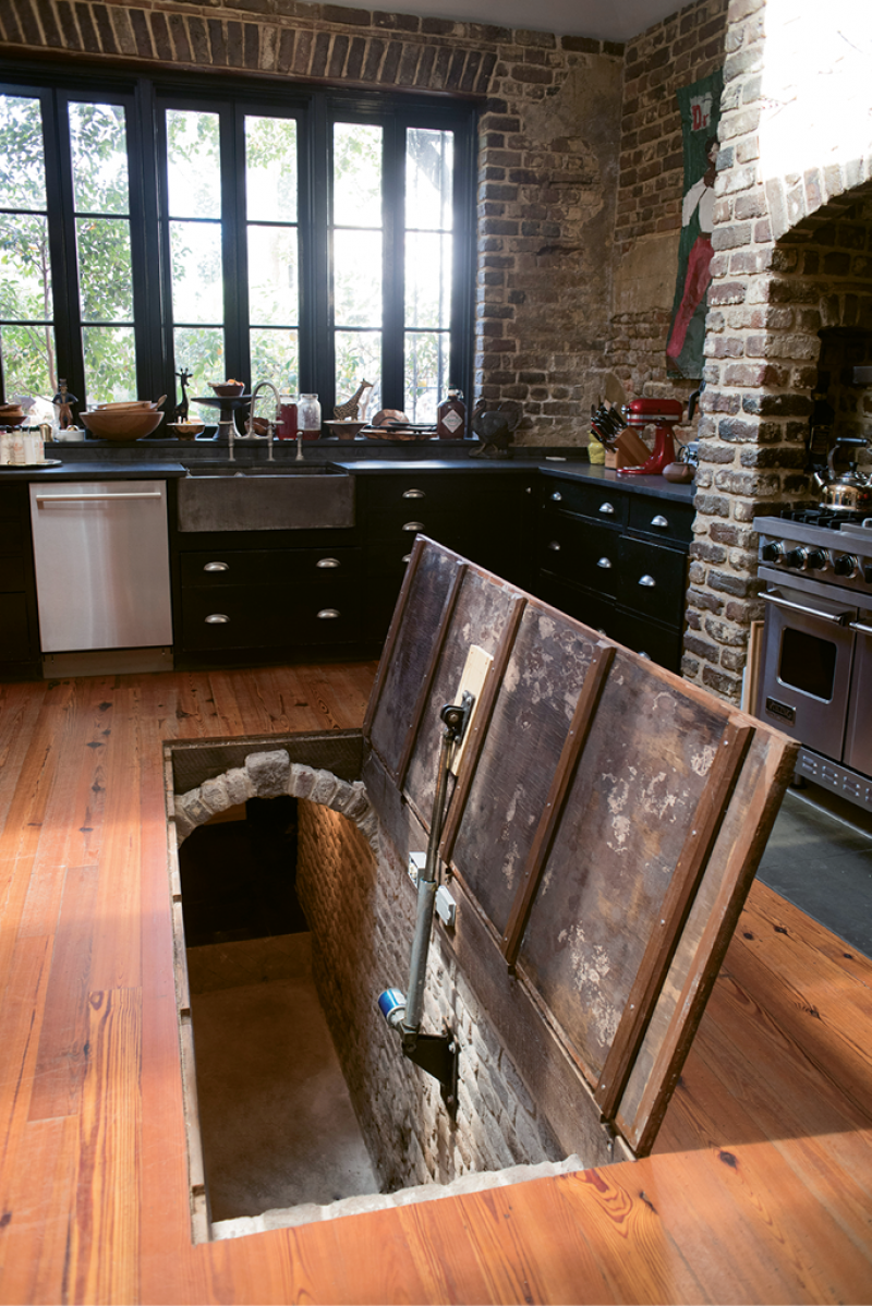 SECRET PASSAGE: Under the rolling kitchen island lies a hidden stairwell to the cistern, which the Pollaks use for storage.