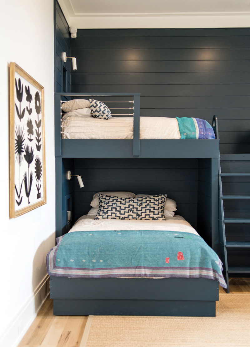 Ship Shape - To add unifying color and interest—not to mention make cleanup a breeze—interior designer Hollis Erickson had the bunk wall covered in ship-lap and painted it all “Hague Blue” by Farrow &amp; Ball.  Location: Daniel Island  Issue: July 2019,  “High-Style Haven”  Photographer: Marni  Rothschild Durlach