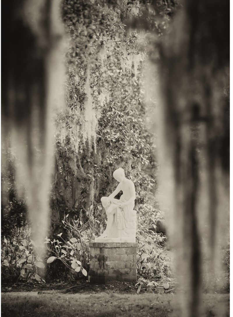The Wood Nymph statue resting beneath festoons of Spanish moss at Middleton Place.