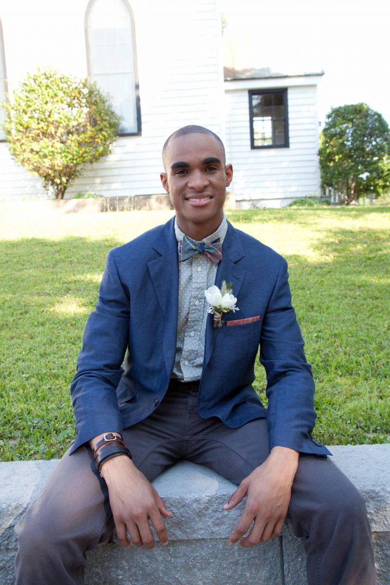 STEP UP: Bruno Cucinelli jacket from Gwynn&#039;s of Mt. Pleasant. Gitman Bros. polka-dotted chambray shirt and Billy Kirk’s leather cuffs, both from Indigo and Cotton. Canvas chinos and canvas “Indianola” chukka boots, both from Billy Reid. Brinko Ties’ “Hippy Chic” plaid reversible bow tie from Rogue Wave Surf Shop.