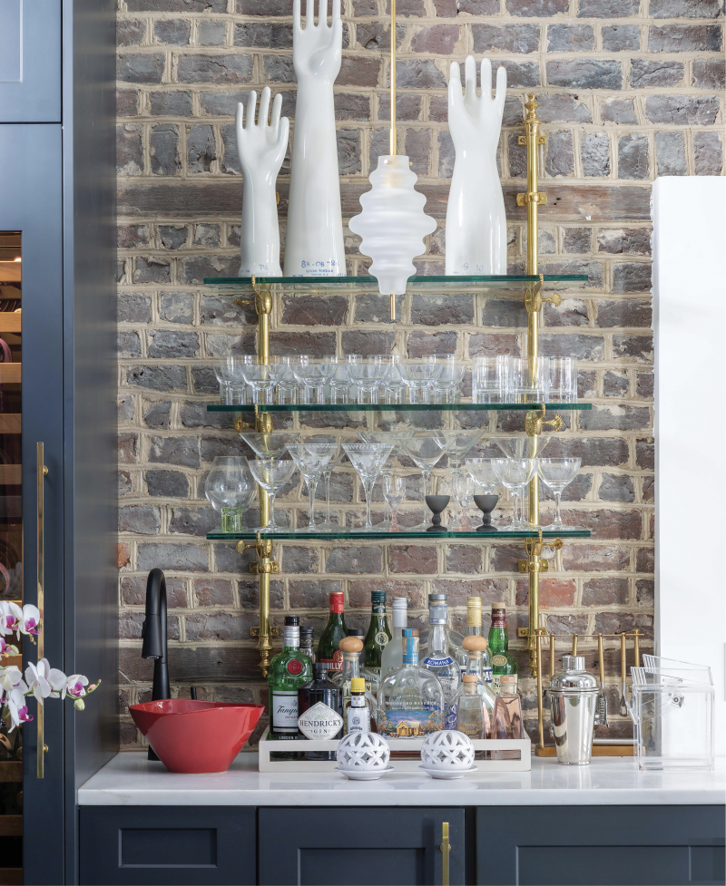High Touch - Vintage porcelain glove molds provide personality to this space, a “hyphen” connecting the single house to its guest suite, which was transformed into a chic entertaining space, complete with wet bar.  Location: Ansonborough (owned by Betsy and Bruce Finley)  Issue: February 2020, “A Twist  on Tradition”  Photographer: Julia Lynn
